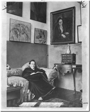 Gertrude Stein in front of paintings
